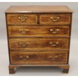 A George III later geometrically line inlaid crossbanded chest of drawers. 100 cm wide.