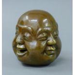 A four faced bronze Buddha head. 11 cm high.