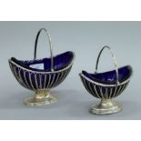 Two George III silver sugar baskets with blue glass liners, each hallmarked for London 1804,