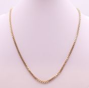 A small 9 ct gold chain. 44 cm long. 12.9 grammes.