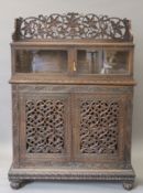 A 19th century Anglo-Indian carved side cabinet. 120 cm wide.
