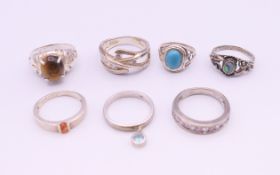 Seven various silver rings.