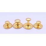A set of four gold fronted studs.