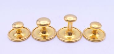 A set of four gold fronted studs.