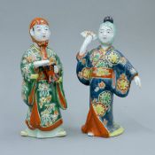 A pair of Japanese Meiji period porcelain figures. Each approximately 19 cm high.