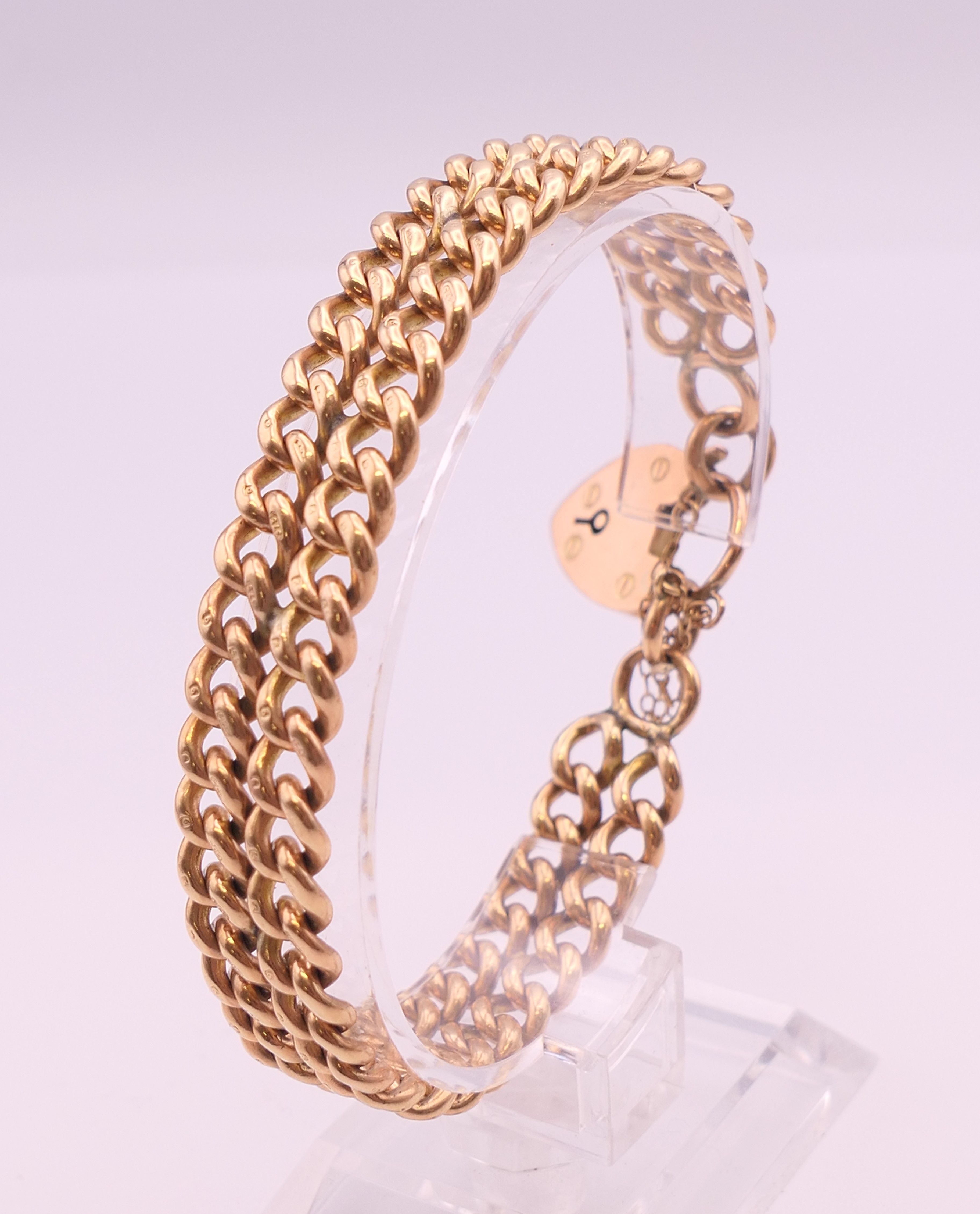 A 9 ct gold bracelet and charms. Bracelet 18 cm long. 58.6 grammes. - Image 5 of 17