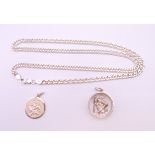 A silver necklace and two silver St Christopher pendants. Chain 50 cm long.