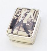 A silver pill box depicting Elvis Presley. 3.25 x 2.5 cm.