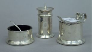 A three-piece silver cruet set. The pepper 7.5 cm high. 148.4 grammes total weight.