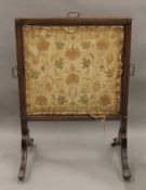 A 19th century mahogany tapestry inset fire screen. 61 cm wide.