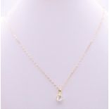 A 9 ct gold and cubic zirconia pendant on a 9 ct gold chain.