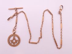 A 9 ct gold watch chain and a 9 ct gold Masonic fob. Chain 38 cm long, fob 2.5 cm diameter. 19.