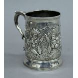 An embossed Georgian silver tankard. 9 cm high. 158.1 grammes.