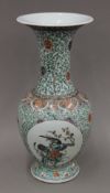 A 19th century Chinese porcelain famille verte vase with an ovoid body and flaring neck. 44 cm high.