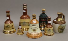 Six Wade Bells Whisky bells (full and sealed) and a flagon of Rutherford's 12 Year Old Scotch