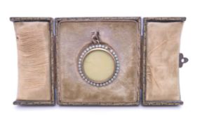 A seed pearl and gold locket, in fitted folding frame case. 2.75 cm diameter.