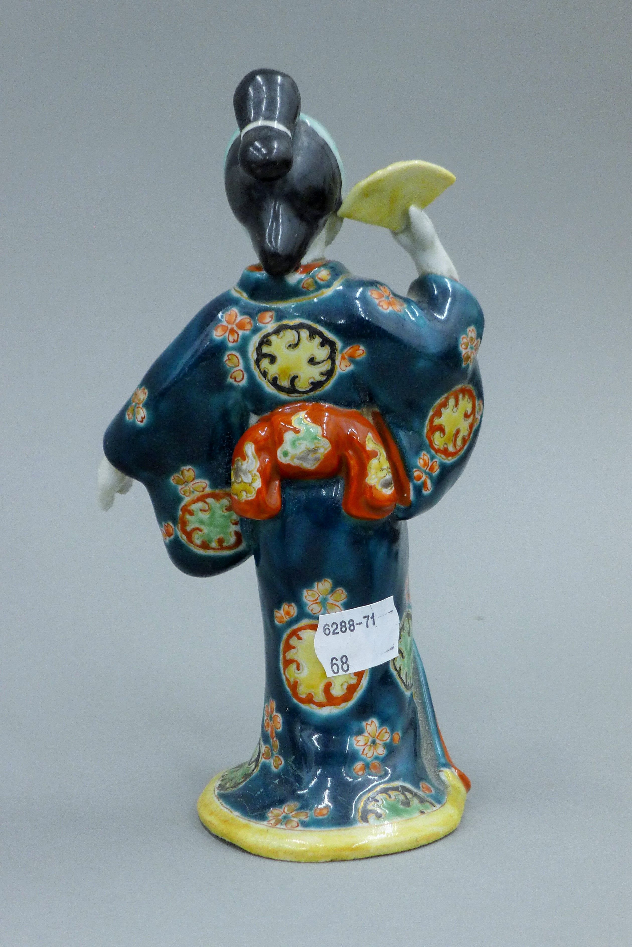 A pair of Japanese Meiji period porcelain figures. Each approximately 19 cm high. - Image 3 of 9