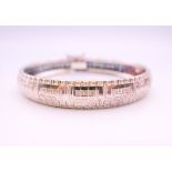 A silver bracelet with Greek key pattern design. 6 cm internal diameter.