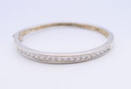 A silver stone set bracelet. 5.75 cm internal diameter.