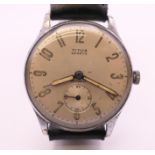 A Titus stainless steel mechanical wristwatch, silvered dial with Arabic numerals,