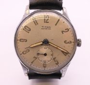 A Titus stainless steel mechanical wristwatch, silvered dial with Arabic numerals,
