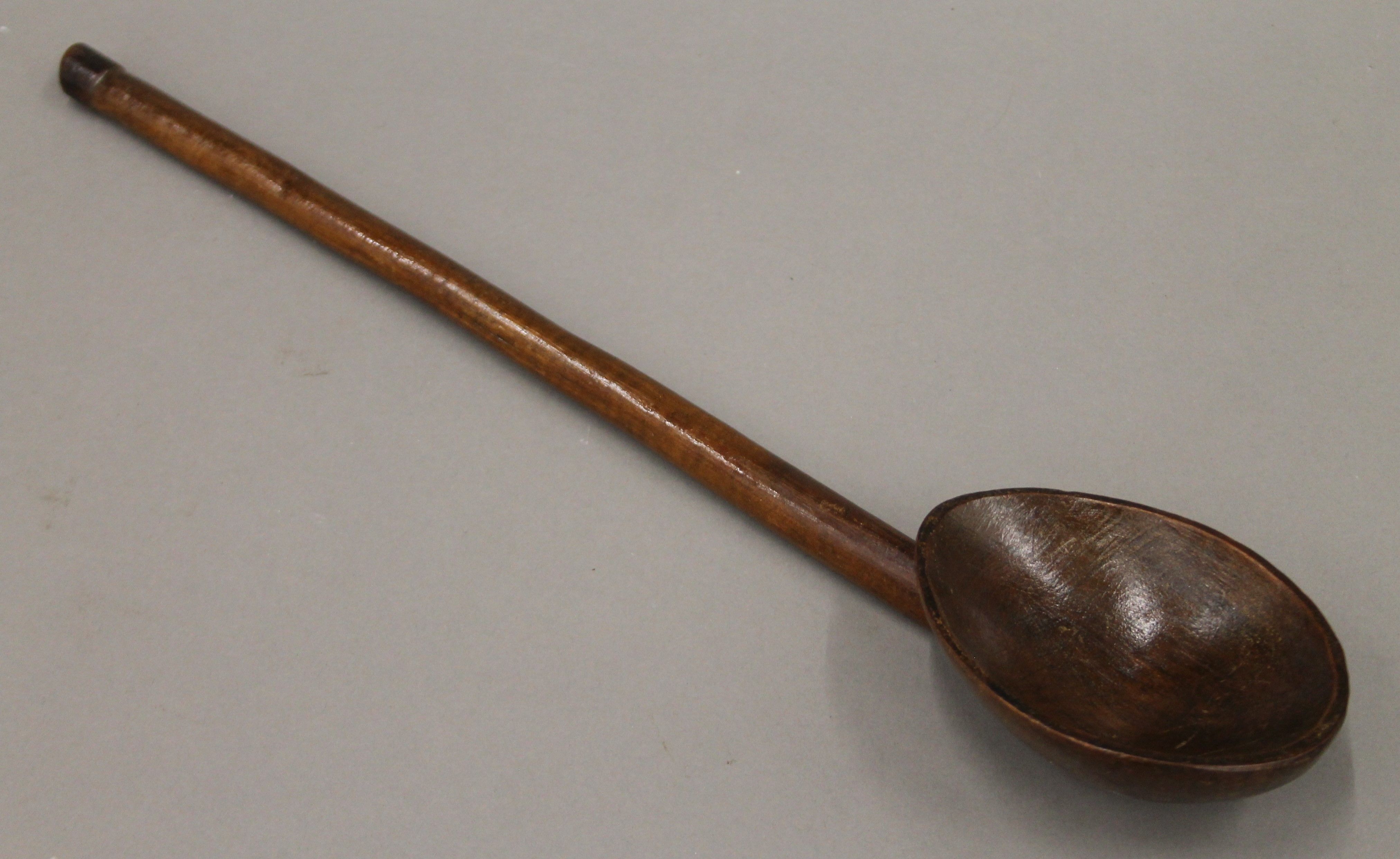 A finely carved South African wooden ladle and two small wooden headrests. The former 44 cm long. - Image 2 of 3
