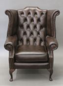 A wing back armchair. 80 cm wide.