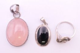 Two silver pendants and a ring. Largest pendant 3 cm high excluding suspension loop.