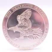 A 1 ounce fine silver Peregrine Falcon Baird & Co coin.