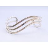 A silver bangle form bracelet.