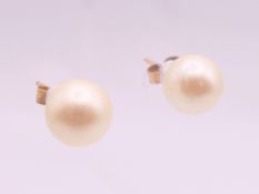 A pair of 9 ct gold pearl earrings. 7 mm high.