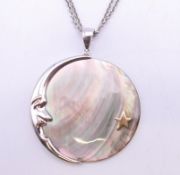 A silver and abalone moon and star pendant on a silver chain. Pendant 3.