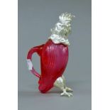 A small silver plate mounted cranberry glass claret jug. 12 cm high.