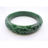 A carved bangle. 6 cm internal diameter.