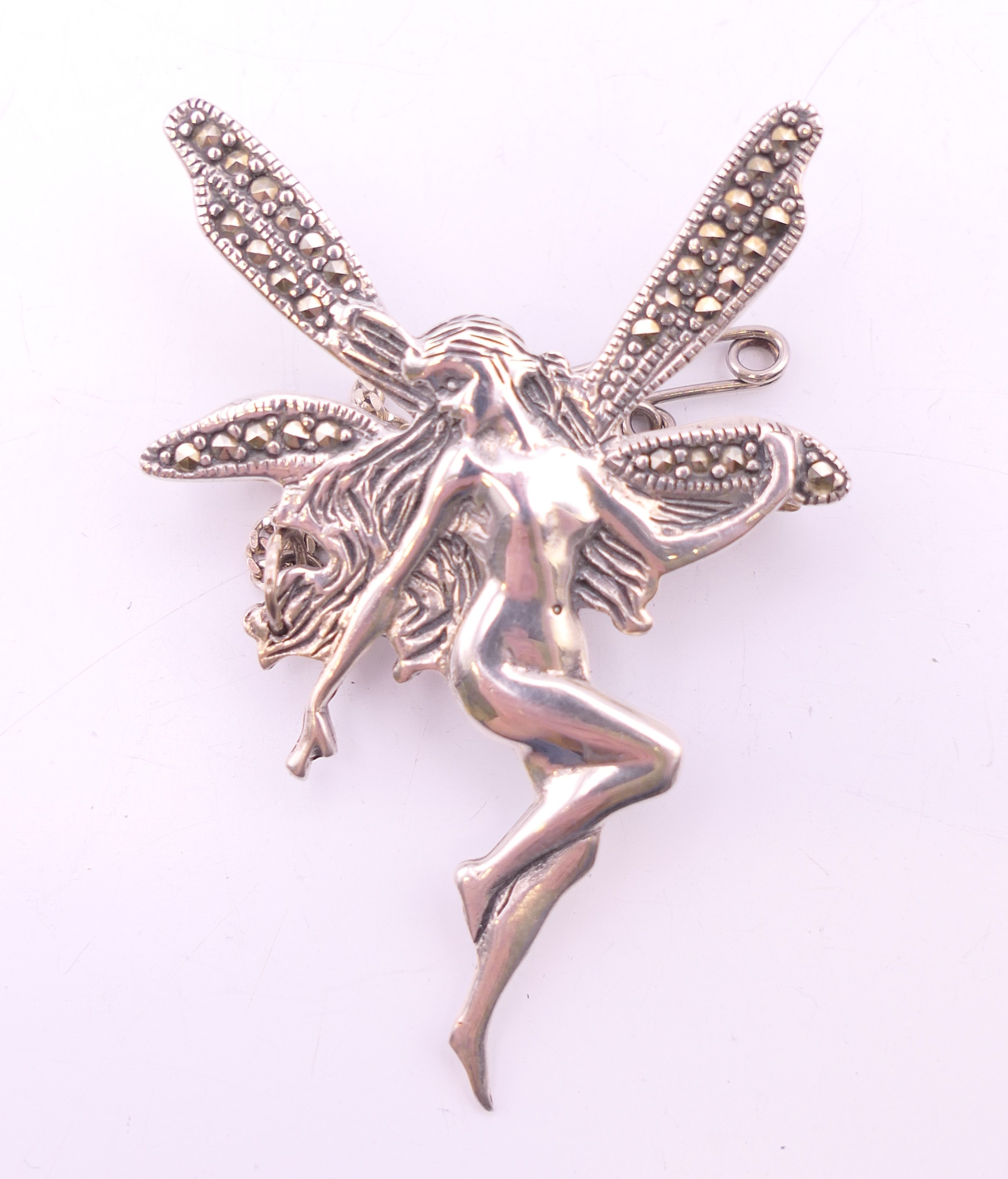 A silver fairy form brooch. 5 cm high.