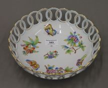 A Herend porcelain pierced bowl decorated with flowers and butterflies. 23.5 cm diameter.