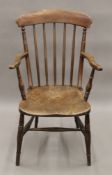 A Victorian elm seated stick back open armchair. 53 cm wide.