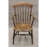 A Victorian elm seated stick back open armchair. 53 cm wide.