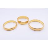 Three 22 ct gold wedding bands. 9.5 grammes.