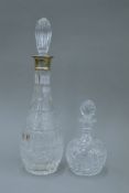 A silver collared cut glass decanter and another cut glass decanter. The former 37.5 cm high.