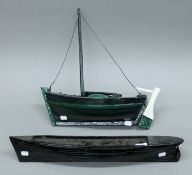 A handmade model of a sailing boat and a planked hull of a boat. The latter 59 cm long.