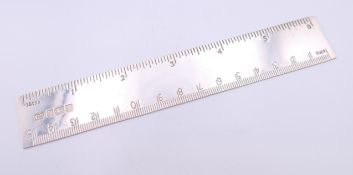 A silver 15 cm ruler, hallmarked for Sheffield 1994. 16 cm long overall. 40.3 grammes.
