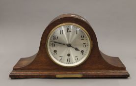 A large Napoleons hat shaped clock with full Westminster chimes movement and brass dedication