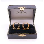 A pair of cufflinks stamped Omega, boxed. 1.75 cm high.