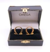 A pair of cufflinks stamped Omega, boxed. 1.75 cm high.