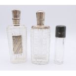 Three silver topped glass perfume bottles. Tallest 9 cm high.