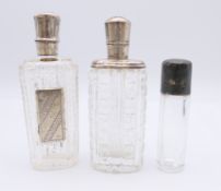 Three silver topped glass perfume bottles. Tallest 9 cm high.
