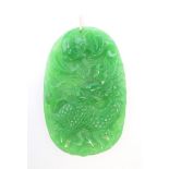 A gold mounted apple green jade pendant. 9 cm high.