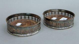 A pair of silver plated bottle coasters. 13 cm diameter.