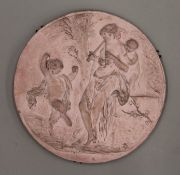 A terracotta plaque depicting a classical scene. 29 cm diameter.